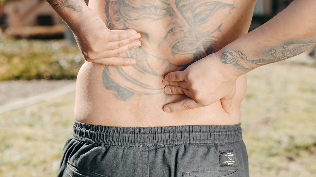 person touching lower back in pain